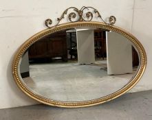 A wooden framed gold painted oval hall mirror 80cm x 105cm