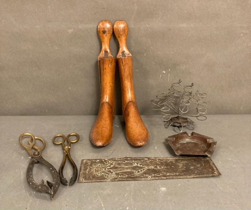 A selection of wooden, brass and metal items to include fire tongs an ash tray and shoe lasts