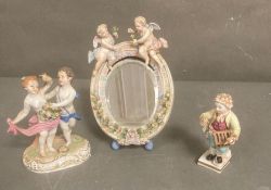 A selection of 19th Century porcelain items to include two figures and a mirror in the manner of