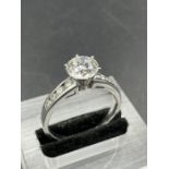 A diamond ring comprising 4 natural full cut round diamonds measuring 2.8mm-3.00mm channel set on