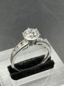 A diamond ring comprising 4 natural full cut round diamonds measuring 2.8mm-3.00mm channel set on