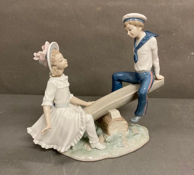 Seesaw. A boy and girl playing on a seesaw. Lladro. Designed by Vincente Martines. #1255. Marked “ - Image 2 of 5