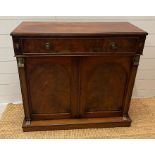 An Empire style side cabinet with arched panelled doors (H85cm W90cm D34cm)
