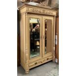 A French style double wardrobe or armoire, the double doors flanked by fluted columns and opening to
