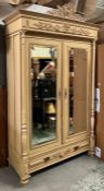 A French style double wardrobe or armoire, the double doors flanked by fluted columns and opening to