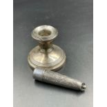 A silver squat candlestick with indistinct hallmarks along with a cheroot holder case (Hallmarked