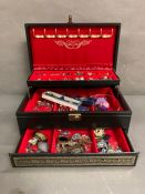 A leather jewellery box containing a large collection of costume jewellery.