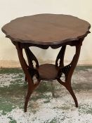 A scrolled Edwardian window table shaped top mounted on out curved legs and feet which are jointed