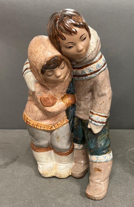 A Lladro Eskimo boy and girl (H38cm W20cm)