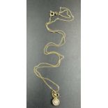 An 18ct gold fine necklace with diamond and heart pendants (Approximate total weight 3g)