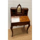 A late Victorian burr walnut Bonheur De Jour desk, the orchard mirror back with drawer flanked by