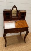 A late Victorian burr walnut Bonheur De Jour desk, the orchard mirror back with drawer flanked by