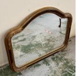 A shaped mirror with floral corners