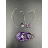 An amethyst pendant and earrings