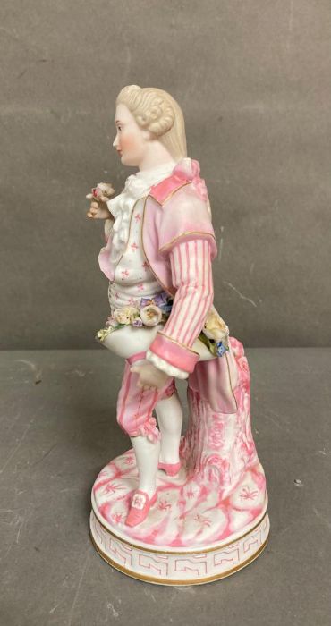 An 19th Century Bisque figure of a gentleman holding a hat with flowers - Image 3 of 4