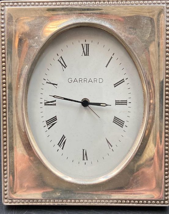 A silver framed Garrard clock, hallmarked for London.