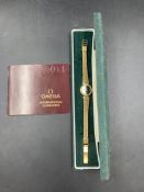 A Ladies Omega watch with gold metal bracelet,