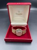 An Omega watch on a hallmarked 9ct (375) gold strap with original box