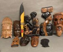 A selection of wall hanging tribal masks and carvings