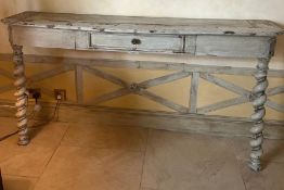 A wooden console table with barley twist and drawer to centre with a distress painted patina (