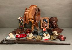 A large selection of wall hanging plaques, masks and tribal treen