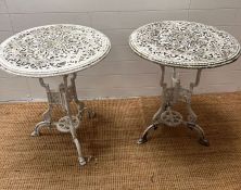 A pair of painted white metal bistro tables