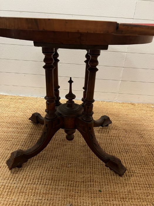 A Victorian card table, inlaid canted top on four turned supports and out swept legs with a turned - Image 4 of 7