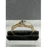 A sapphire and diamond twist ring, set with three sapphires, weighing an estimated total of 0.12ct