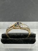 A sapphire and diamond twist ring, set with three sapphires, weighing an estimated total of 0.12ct