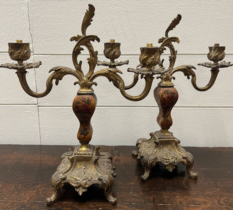 A pair of gilt bronze twin branch holders in rococo style with a painted body on square base, fitted - Image 2 of 5
