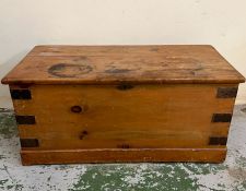 A pine chest with metal bounding (H43cm W92cm D46cm)