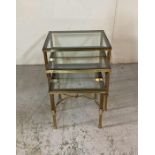 A nest of three brass side tables with smoked glass tops (H47cm W56cm D46cm)