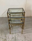A nest of three brass side tables with smoked glass tops (H47cm W56cm D46cm)