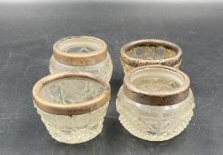 Two pairs of hallmarked silver rimmed cut glass salts.