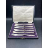 A boxed set of silver handled butter knives, hallmarked for Sheffield 1919 by John Biggin