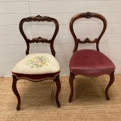 Two carved mahogany balloon back chairs, one with pink upholstered seat the other with floral