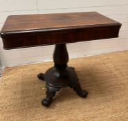 A Victorian tea table the hinged swivel top on an octagonal bulbous column on four scrolling feet (