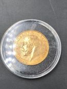 A 1913 gold sovereign coin encapsulated