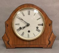 A mahogany cased inlaid eight day mantle clock