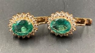 A pair of 18ct emerald and diamond earrings
