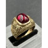 A synthetic ruby signet ring, central cushion shaped, cabochon cut synthetic ruby measuring 11.8 x