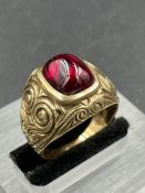 A synthetic ruby signet ring, central cushion shaped, cabochon cut synthetic ruby measuring 11.8 x