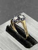 A sapphire and diamond double cluster ring, two daisy clusters each with a central round brilliant