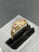 An early 20th Century diamond and garnet boat ring, set with a central rose cut diamond weighing