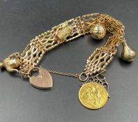A 9ct gold charm bracelet, including a 1910 sovereign. Approximate total weight 49.4g