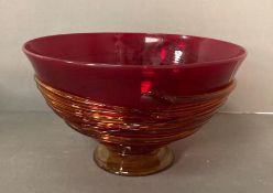 A large red ribbed art glass bowl