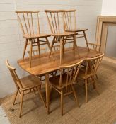 An Ercol Mid Century table and nine chairs (H71cm W150cm D75cm)