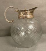 A large spherical cut glass jug or pitcher H27