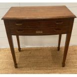 An oak cutlery table on tapering legs and two drawers fitted for a cutlery