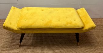 A velvet yellow bench seat on tapering legs (H42cm W127cm D49cm)